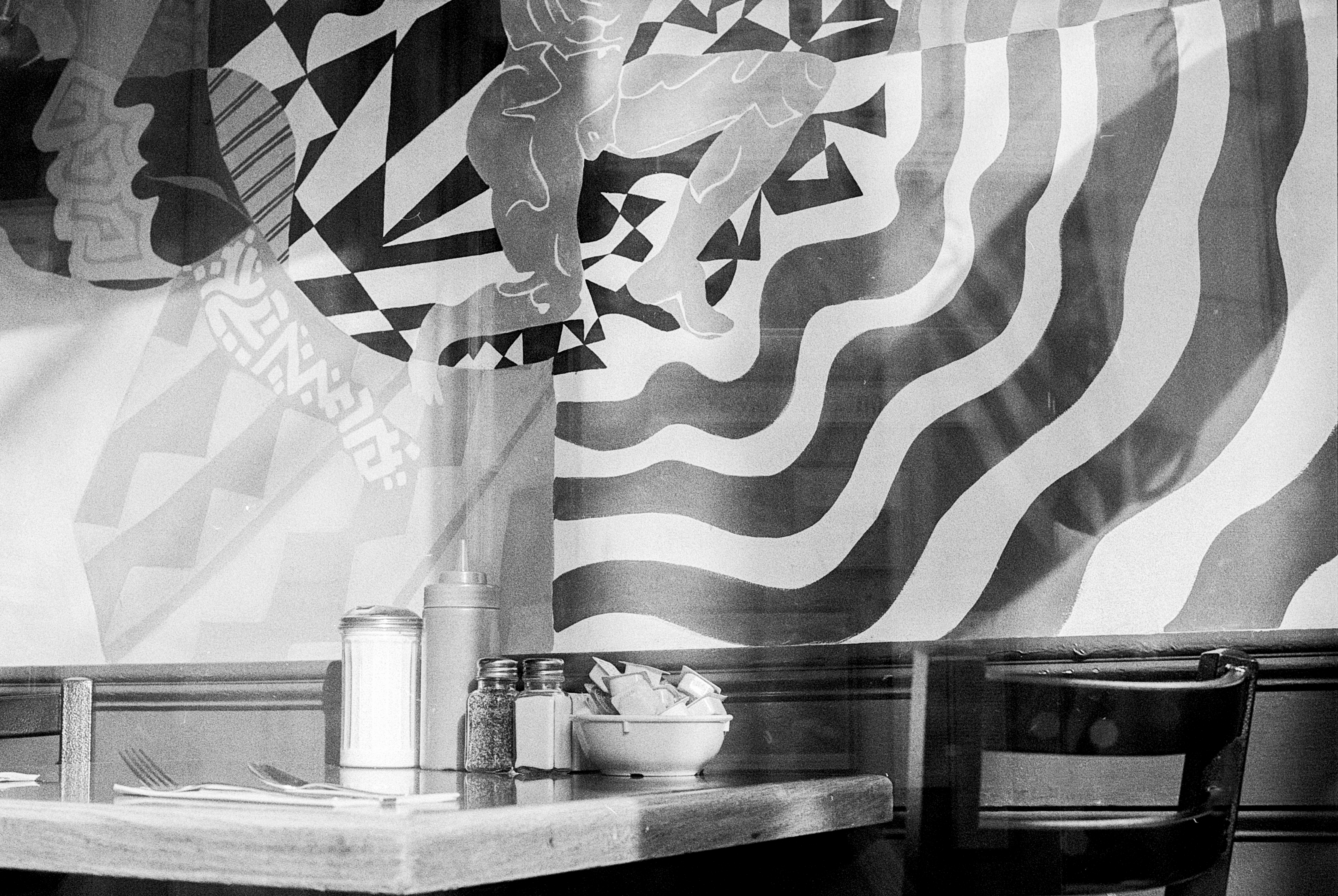 An Empty Table in a Diner on Wickenden Street Near the Antique Store That has Kens and Barbies Stacked on Top of One Another
